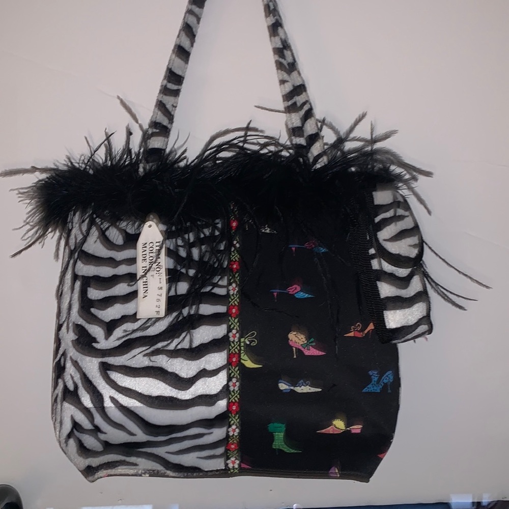 Medium sized, canvas shoe print AND faux fur zebra print handbag. Black interior